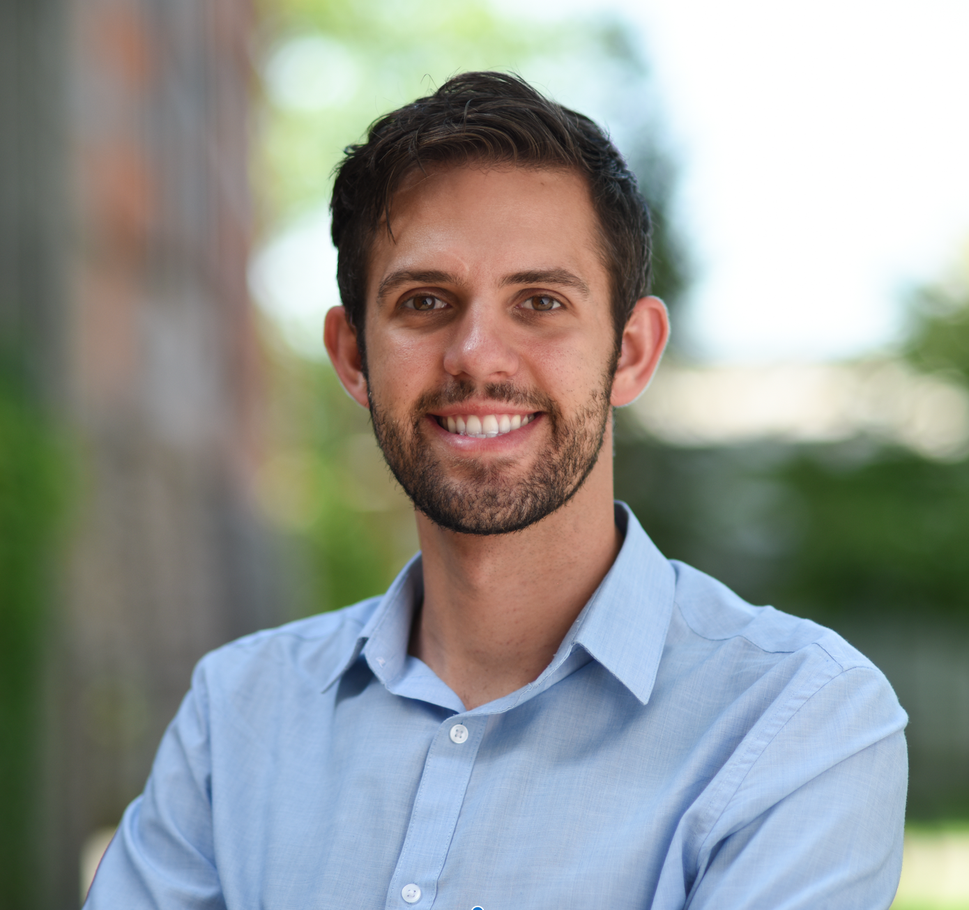 Photo of Zack Zappone who has medium brown, short hair and is wearing a blue collar shirt.